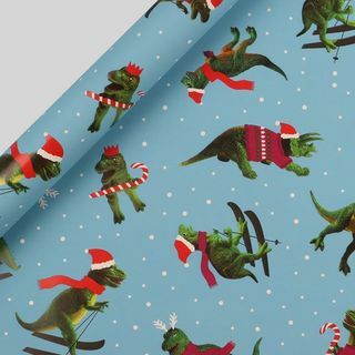 Papel de regalo de Navidad dinosaurios esquiando 